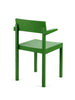 Green dining chair with arm rests on a white background. Seen from behind.