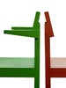 Close up of two dining chairs back to back. One chair is bright green with an arm rest. The other one is red without a arm rest.