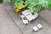 Yellow and white garden furniture in a leafy garden at spring time.