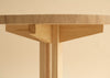 Studio photo. 001 Dining table in round version. Close up. Beige background.