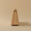 A rocking toy made from pine that looks like a seal. View straight from the front. Beige bakgrunnur.