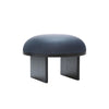 Product image. A elegant soft shaped pouf with black legs and dark blue high quality leather seat. White background.