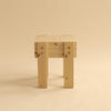 003 Ast stool shown from the side. Studio image with beige background.