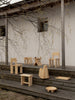 A collection of Vaarnii products. Photo taken outside on the porch. 002 Ast stool in the foreground with chairs, side tabls and other smaller items around and in the background
