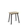 Adorable little stool with black metal legs and wooden seat. White background.