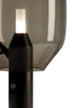 Nærmynd af glæsilegum borðlampa úr svörtum marmara með skyggðum gler skermi. Kveikt er á lampanum. Hvítur bakgrunnur.