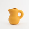 A yellow water jug in mat ceramic. White background.