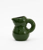 Ceramic water jug. Cute and soft shapes. Glossy texture. Dark green colour. White background.