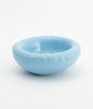 A round, baby blue ceramic bowl on a white background. The bowl is empty.