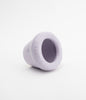 A small and cute ceramic flower pot sits on its side. White background.