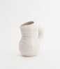 A super cute water jug in white, glossy ceramic. White background.