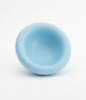 A small and round ceramic bowl in baby blue on a white background. The bowl is empty.
