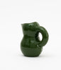 Dark green and glossy ceramic water jug. White background.