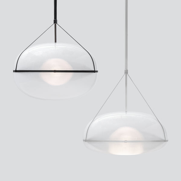 Two gorgeous, large pendant lights next to each other. White background. The light on the left is slightly higher up and has a black suspension. The pendant on the right which is lower has white suspension.