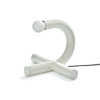 Modern white table lamp with curved design on a white background