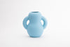 A baby blue ceramic vase in bold and friendly forms. White background.