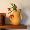 A yellow, mat ceramic vase sits on top of a shelf. Some red and yellow tulips in the vase.