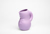 Pale violet water jug made from ceramic on a white background. Bold and cute froms.