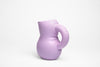 A super cute ceramic water jug in pale violet colour on a white background.