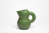 Super cute, mat, moss green ceramic jug on a white background.