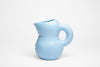 Cute baby blue waterjug in mat ceramics. White background.