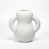 A mat, white and curvy vase on a white background.