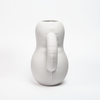 Side view of a curvy, white ceramic vase. White background.