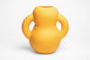 A cartoonish and soft shaped ceramic vase on a white background.