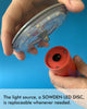 A close up shot of a red rechargeable table lamp that illustrates how simple and easy it is to change the light source if needed. Blue background.