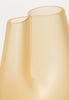A close up of a beautiful handmade vase in pale yellow colour.