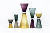 Five gorgeous vases in handmade glass. White background. The vases are side by side in a row. Vases are similar in shape but in different sizes and colours.