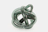Handmade green glass sculpture on a white background.