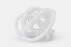 White glass sculpture on a white background.