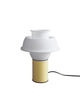 Cute little table lamp on a white background. The lamp is in a pale yellow colour with a white, silicone lampshade. The light is switched off.