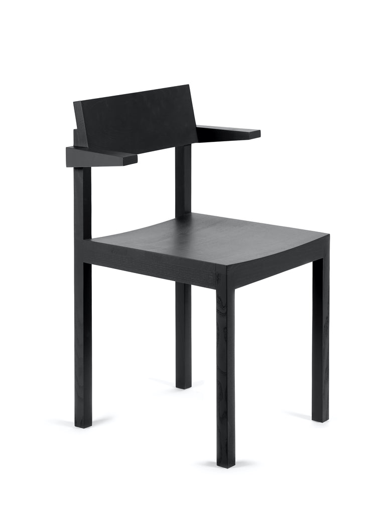 Black dining chair with arm rests made from wood on a white background. 45 degree ankle.