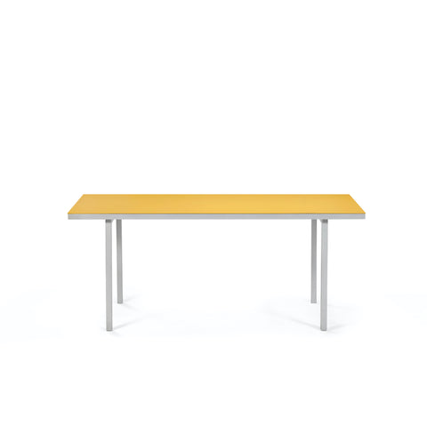 Minimalistic design. A beautiful aluminium dining table with a bright yellow table top. White background.