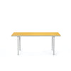 Minimalistic design. A beautiful aluminium dining table with a bright yellow table top. White background.