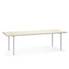A large and minimalistic dining table in aluminium. Ivory coloured table top. White background.