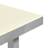 A close up of a corner of a minimalistic dining table made from aluminium. Ivory coloured table top. White background.