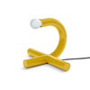 Yellow table lamp with a white bulb on a white background