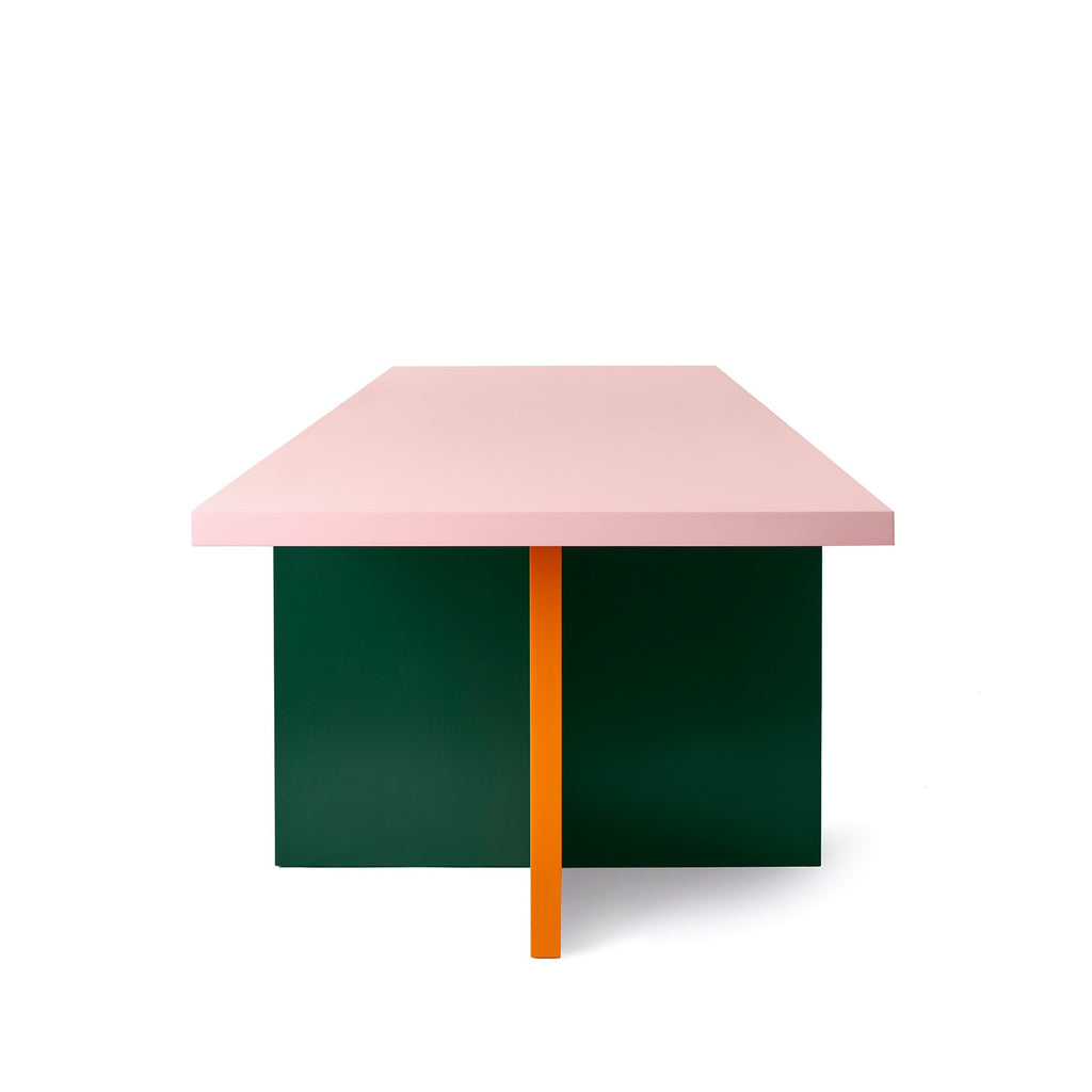 A super modern and minimalistic dining table in vibrant colours. The table is pink, orange and dark green. White background.