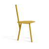 Turmeric yellow dining chair on a white background. View from the side.